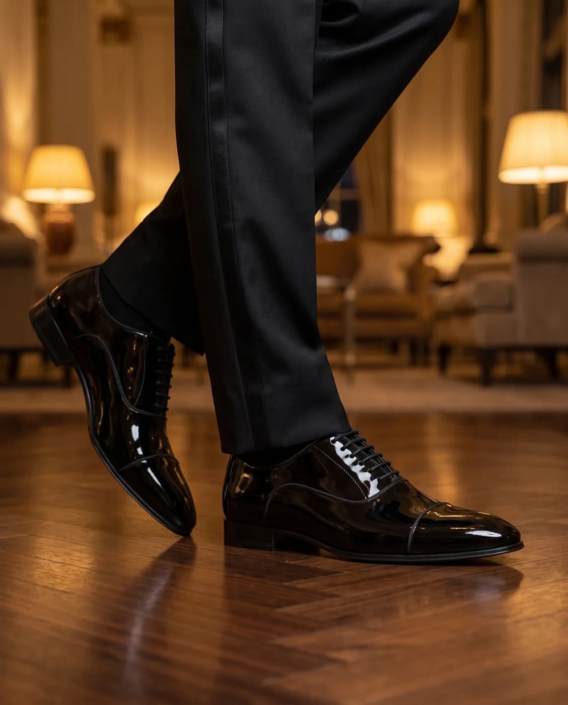 Black patent leather oxfords worn with evening trousers
