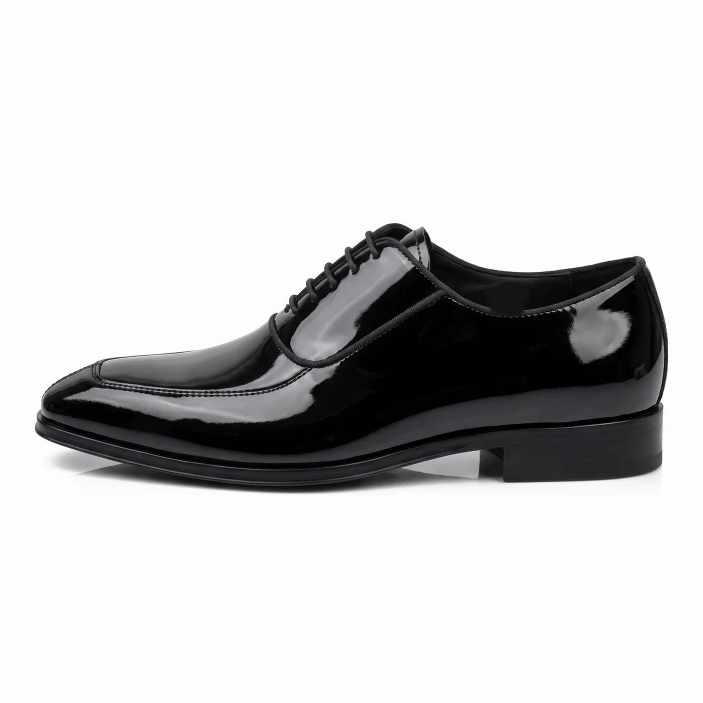 Split toe lace-up, black patent leather, in side profile with a black sole