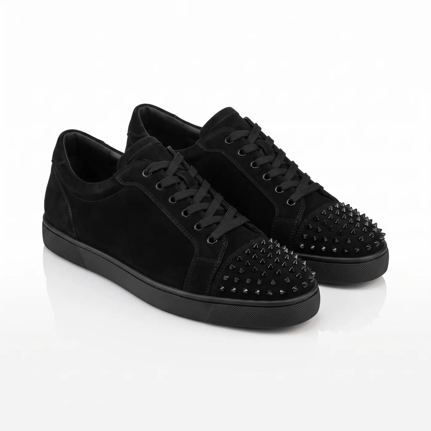 A pair of black spiked low tops