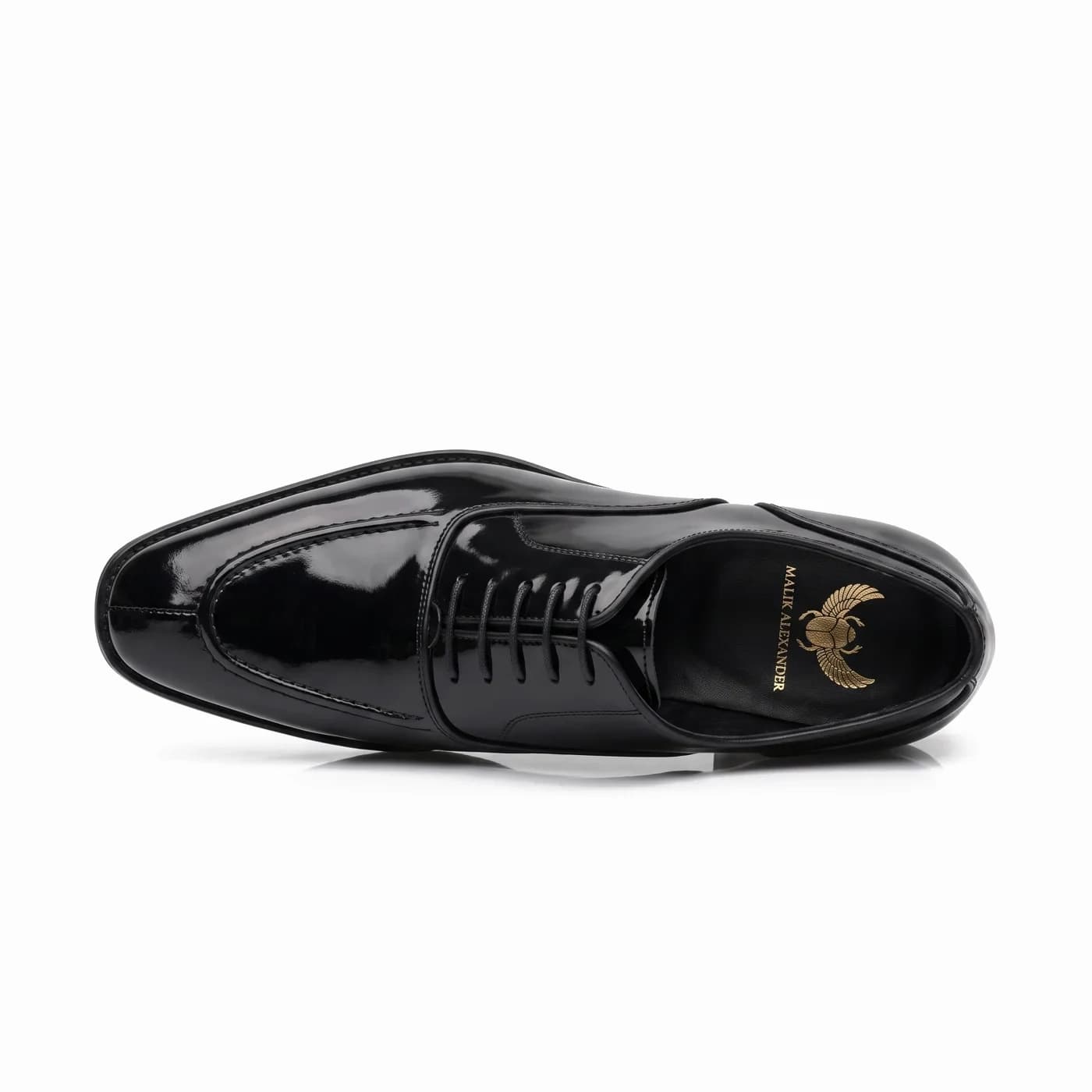 Split toe lace-up, black patent leather, seen from high at an angle, the Malik Alexander logo in gold on the black insole