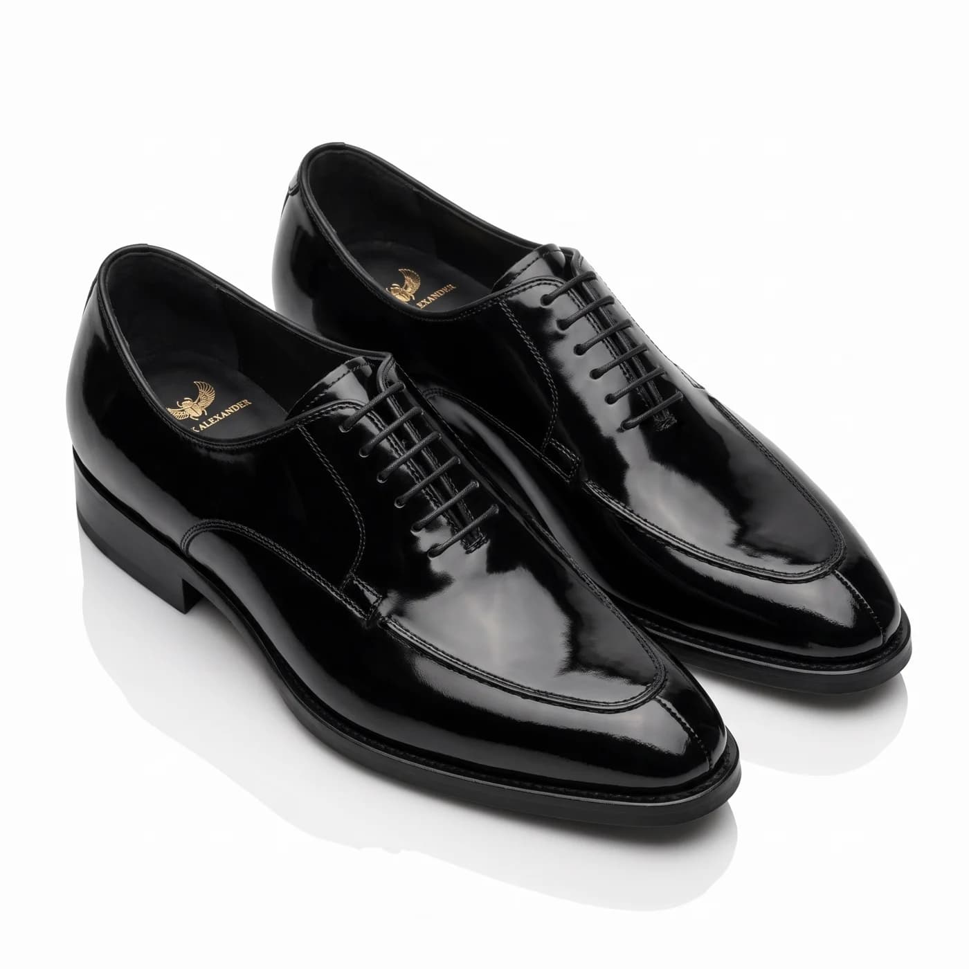 A pair of black patent leather split toe lace-ups